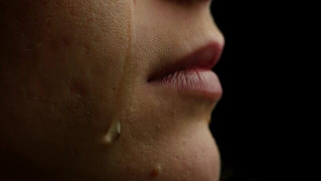 A Tear Running Down a Young Beautiful Woman Face, Macro