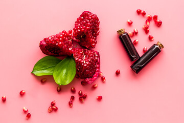 Pomegranate seed essential oil with pomegranate fruit and leaves