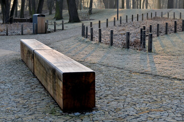 wooden oak prism bench in garden. for better drying of wood, grooves are milled lower part, which...