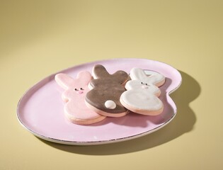 Easter's Finest Dessert Treats: Three Adorable Bunny Rabbit Cookies on a Pastel Pink Plate