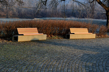park bench has a concrete tube base flattened on the sides. the bench is printed on a 3d printer...