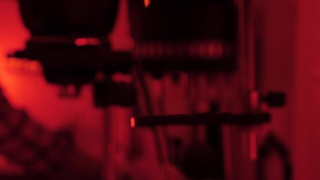 a dark room. Red light. photography as art. close-up of a photo enlarger