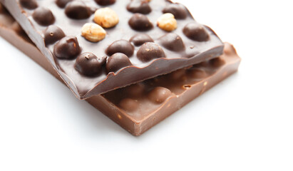 Black and milk chocolate with hazelnuts on a white background