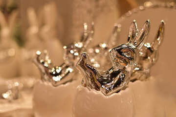 Silver figurines of rabbits in eggs. Easter.