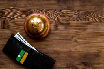 Hotel payment concept with vintage hotel service bell and wallet