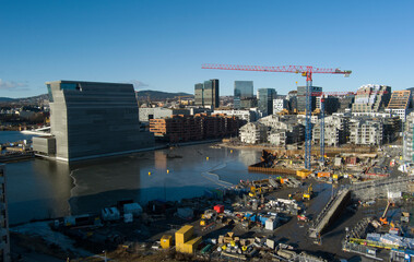 Oslo city from aerial drone view - construction crane and skyline - drone flies towards crane