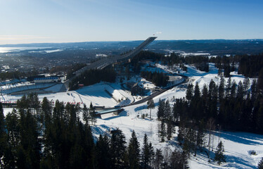 Oslo ski Jump track during winter season - Aerial drone shot in the hills over Oslo city in Norway