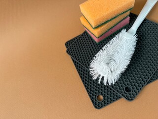 Sponge to wash dishes, brush and silicone tack. Cleaning banner, place for text
