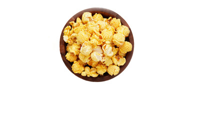 Caramelized popcorn in a wooden cup on a close-up, transparent white background
