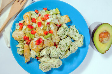 Fried potatoes with bacon and green onion on wooden background, top view.