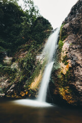 Fototapeta na wymiar the sound of a roaring waterfall, vertical closeup 