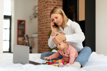 Stressed mother talking to doctor, worried about her little daughter's health, checking child's temperature