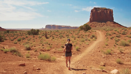 A view of a woman running through the desert, Monument Valley, USA