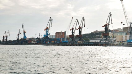 Naklejka premium The seaport of Vladivostok with cranes. View from the ferry.