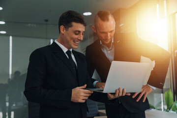 Financial analysts analyze business financial reports on a digital tablet planning investment project during a discussion at a meeting of corporate showing the results of their successful teamwork.