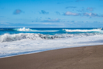 Fototapeta na wymiar Wave bursting on the black sand of Santa Bárbara beach on the island of São Miguel, Azores PORTUGAL