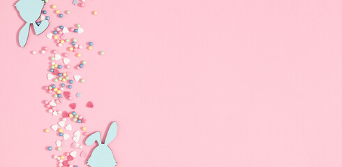 Easter holiday composition. Easter decorations, colorful sugar candy sprinkles isolated on pastel pink background. Easter concept. Flat lay, top view, copy space 