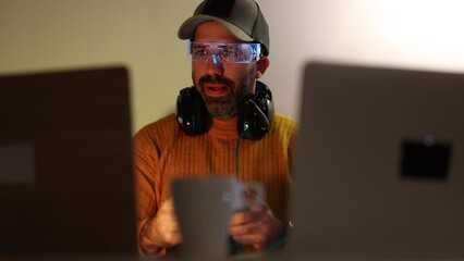 Middle aged man playing with a video game controller celebrating a victory in the winner position