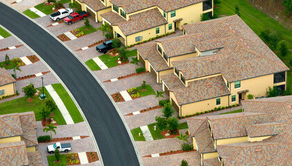 Aerial view of tightly located family houses in Florida closed suburban area. Real estate development in american suburbs