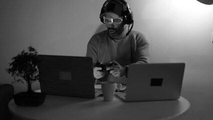 Middle aged man playing with a video game controller celebrating a victory in the winner position