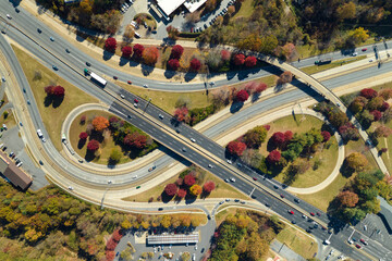 American freeway intersection with fast driving cars and trucks. View from above of USA...