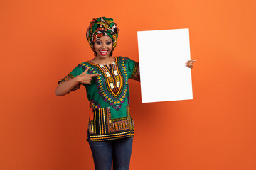 Excited traditional african woman holding white blank placard