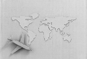 Airplane and world map made of cardboard. Worldwide delivery concept.