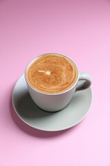 hot cappuccino with latte art on wood background