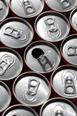 Red soda cans, top view, with one opened