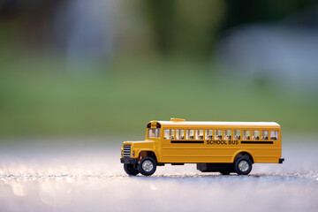 Small model of american yellow school bus as symbol of education in the USA