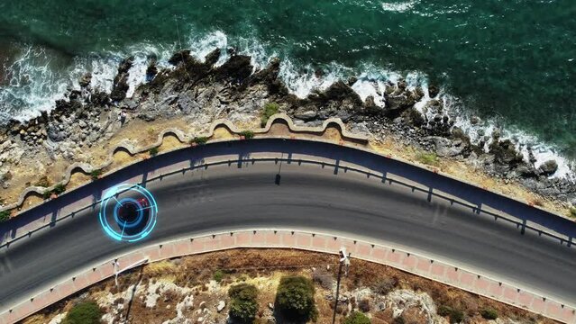 Concept of autonomous self-driving cars. Vehicles drive on the road along the seashore, artificial intelligence controls the vehicles traffic. Artificial intelligence scans environment, detecting cars
