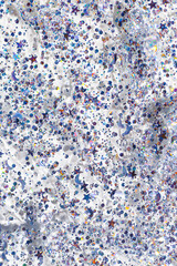 Texture of cosmetic transparent gel with glitters as beauty background. Blue glitter for face, body, hair. Shimmering cosmetic texture gel for festive make up, metallic sparkles as stars