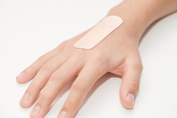 Medical adhesive plaster is pasted on hand of child hand, selective focus