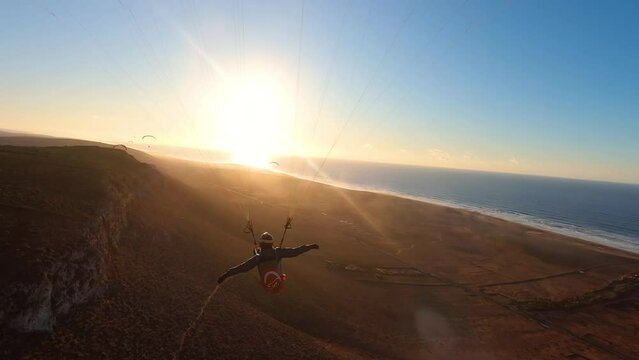Fly like a bird on paragliding wing at beautiful sunset in Ocean coast, Freedom of free flight
