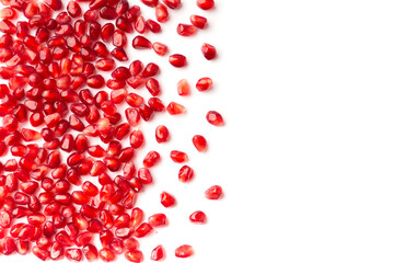 Pomegranate seeds are neatly arranged on a white background top view.