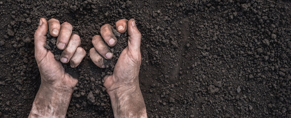 Farmer hands full of soil earth ground. Fertile soil background. Handful of dirt hands holding soil hands touching ground. Organic farming. Save earth day. Chernozem. Ukraine field agriculture concept