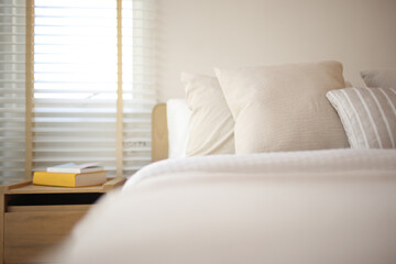 pillow on bed in a modern white tone loft room