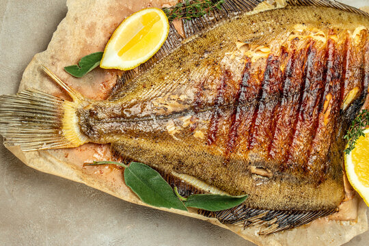 Baked Flounder Fish with herbs and lemon, Delicious balanced food concept, Restaurant menu, dieting, cookbook recipe top view