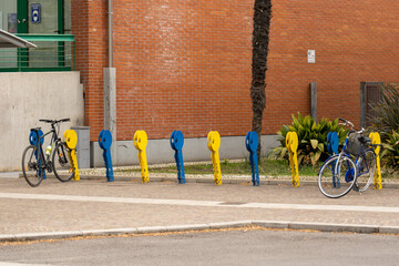 There are yellow and blue bicycle parking lots in the city In the shape of keys
