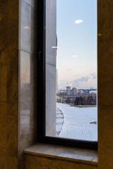 view of park and houses Moscow city from window of building on Poklonnaya Gora at winter dusk