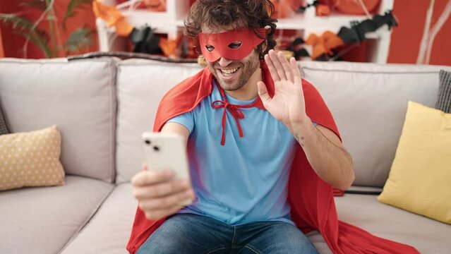 Young hispanic man make selfie by smartphone having halloween party at home