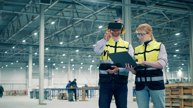 Employees using virtual reality. VR, 3d reality at industrial factory facility.