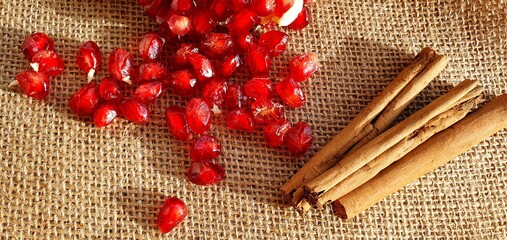Cinnamon sticks and pomegranate seeds. Spice cinnamon. A set of spices for mulled wine. Healthy...