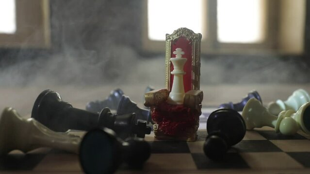 Red royal chair (Medieval Throne) miniature on chessboard. . Chess board game concept of business ideas and competition and strategy ideas concept. Selective focus
