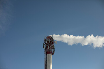 Boiler station pipe. Smoke from chimney. Industrial zone. Steam removal from plant.