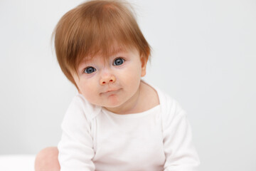 Portrait of cute happy six month baby girl. Childhood and baby care concept