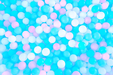 Multi-colored, highly saturated plastic balls under water, in a soft play ball pit. Colorful ball under water.	