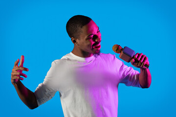 Cool black guy rapper singer performing on blue