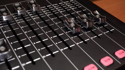 Fototapeta premium The digital audio mixer is self-configuring. The switches move on their own on the sound console. The camera makes a slide.