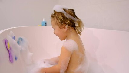 A child bathes in a bubble bath. Selective focus.